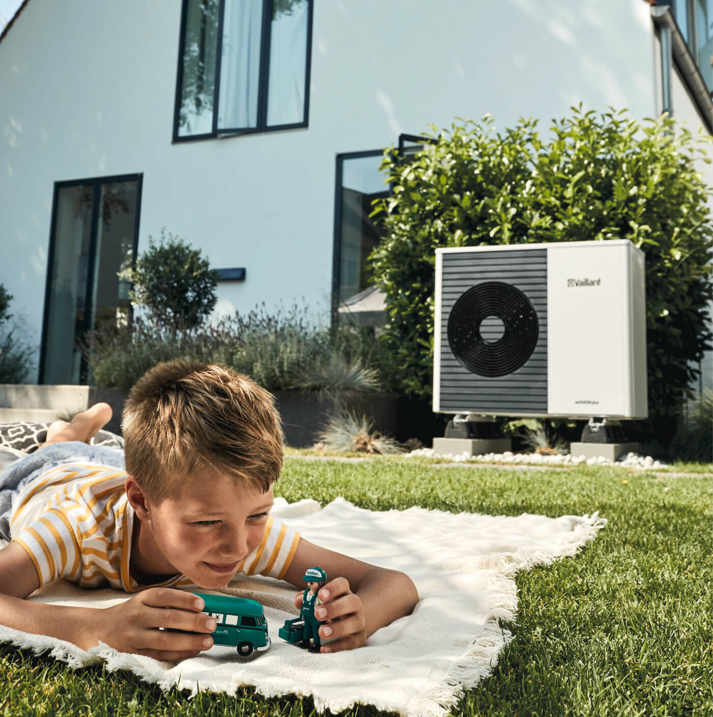 Child playing in garden near heat pump