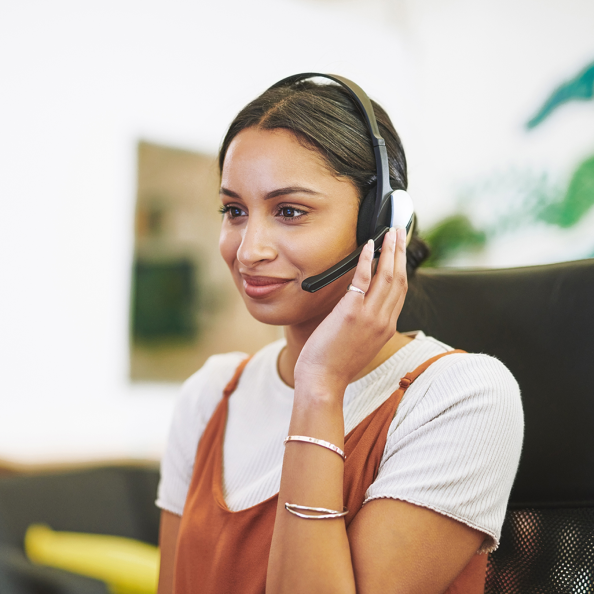 Call centre representative smiling while on a phone call